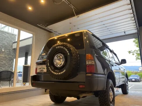 ガレージ内に停車した黒いトヨタSUVの後方からのアングル